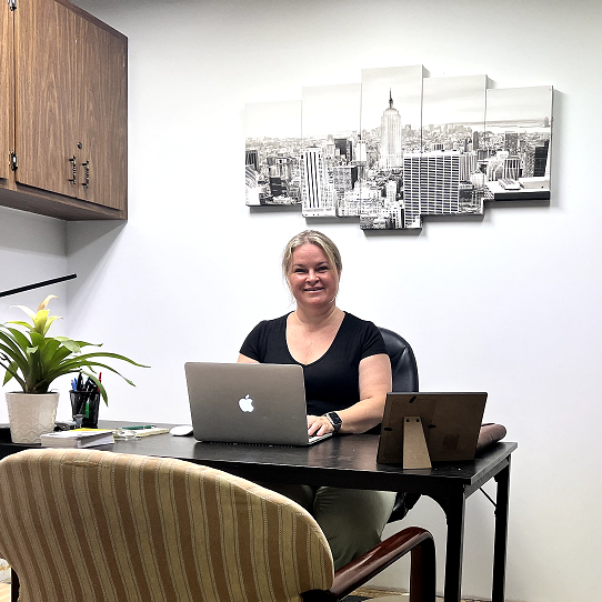 Dora Orgovan, Office and Financial Administrator at TriGuard Restoration Services, working at her desk in the company office.