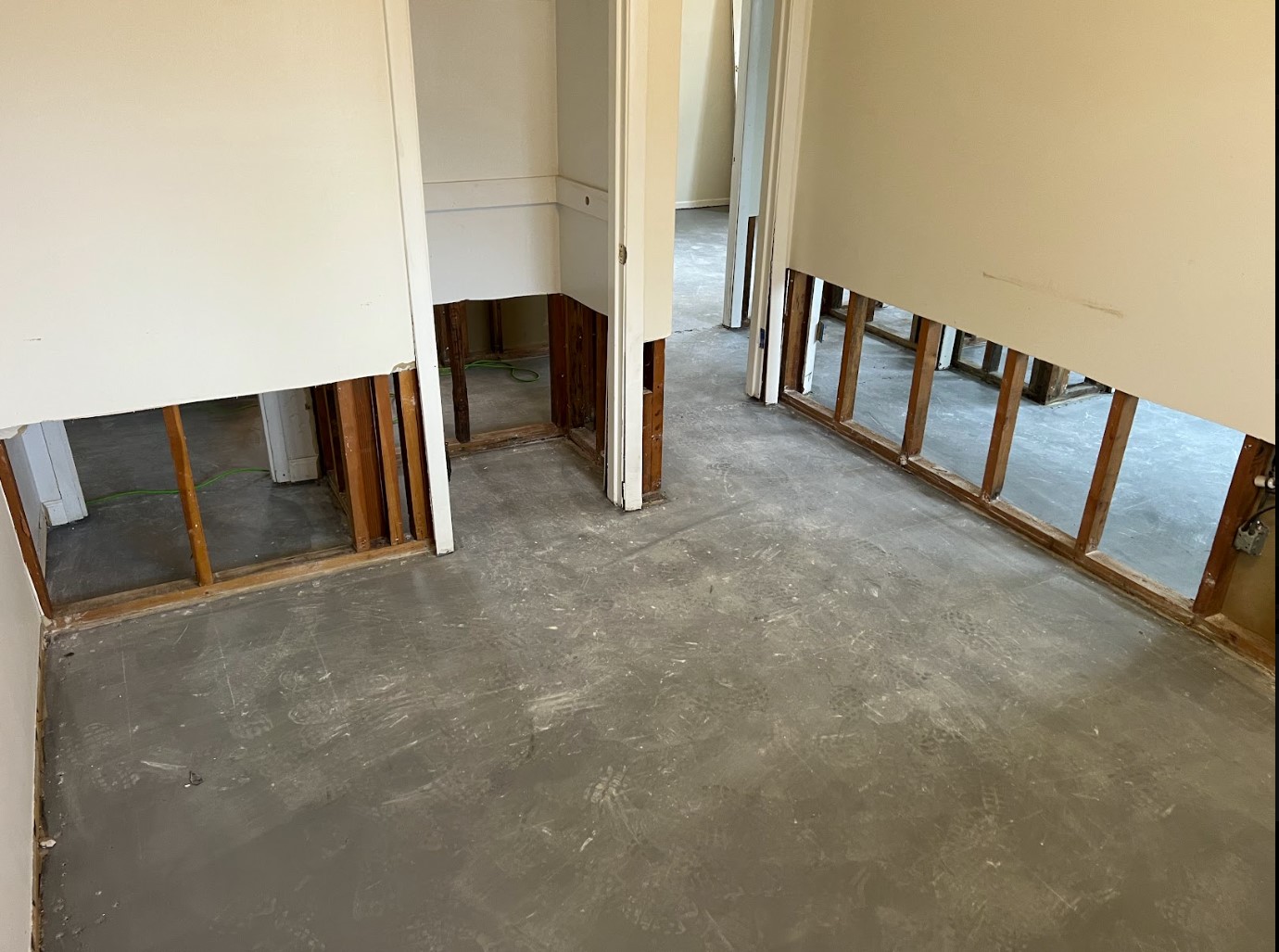 Exposed wall framing and bare subfloor during a water damage restoration project in North Royalton, OH