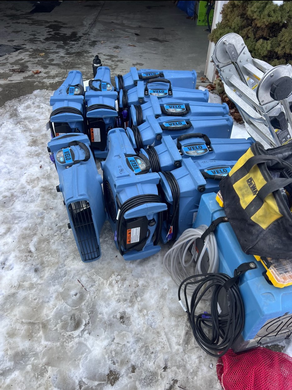 Air movers and drying equipment staged outside after a winter water damage job in Chagrin Falls, OH