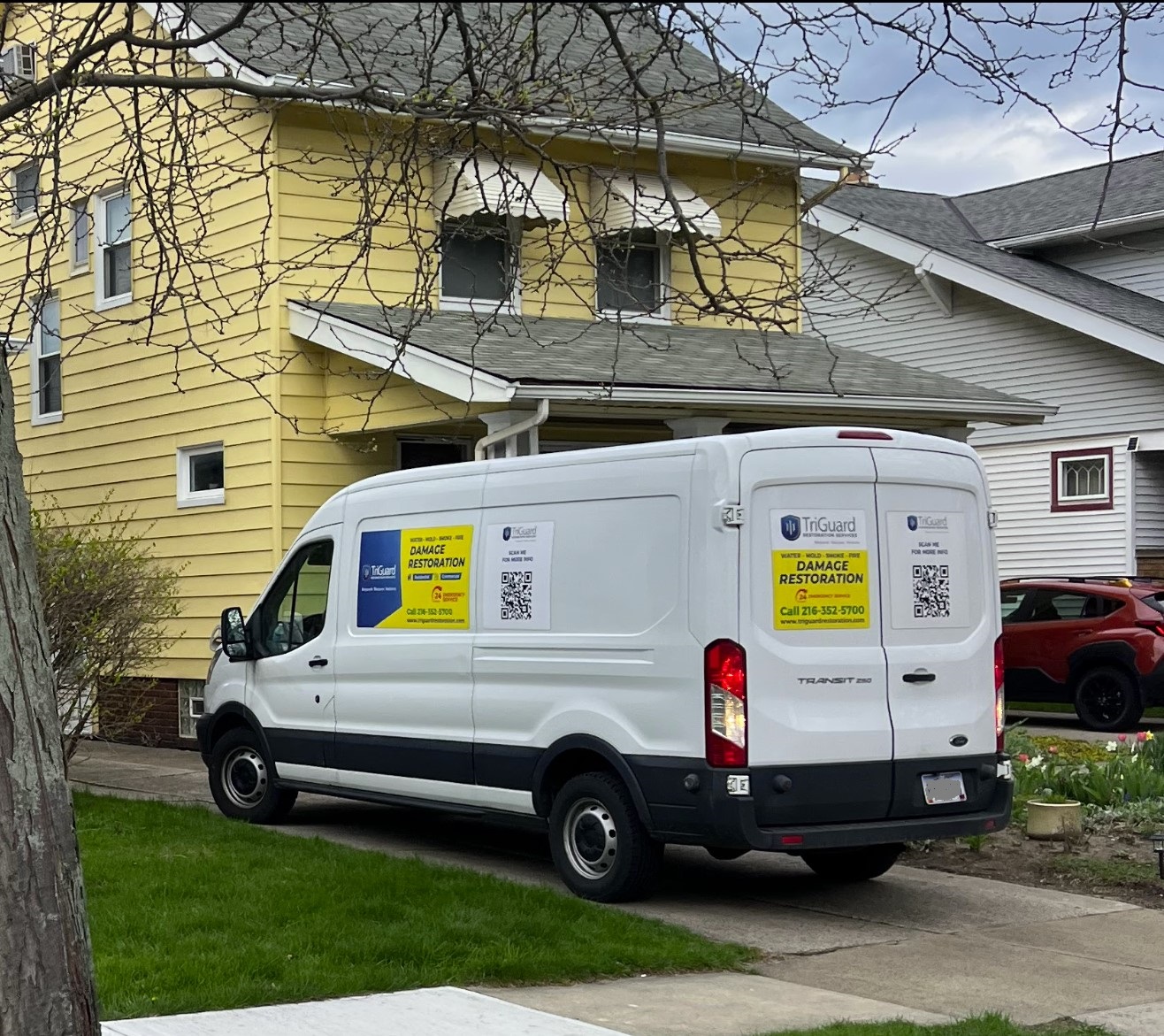 TriGuard Restoration service van parked outside a Lakewood, OH home during a water damage response