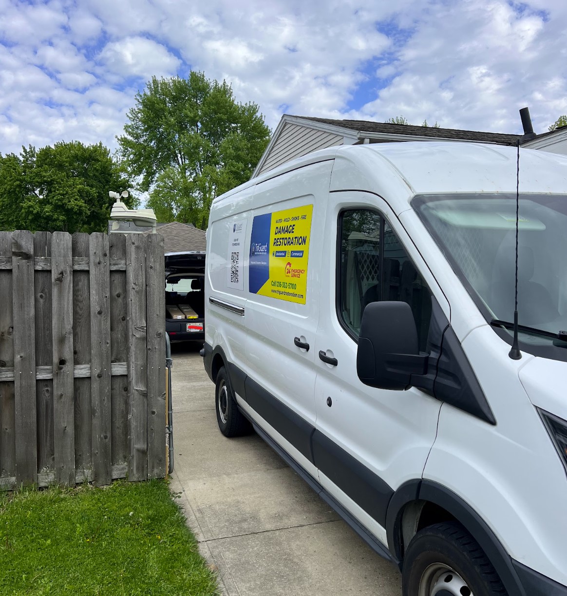 TriGuard Restoration van arriving at a residential driveway for a water damage job in North Royalton, OH