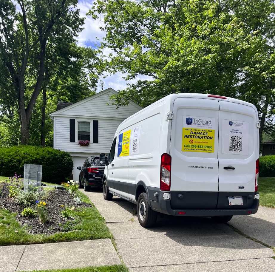 TriGuard Restoration van parked in a residential driveway responding to a water damage call in Chagrin Falls, OH