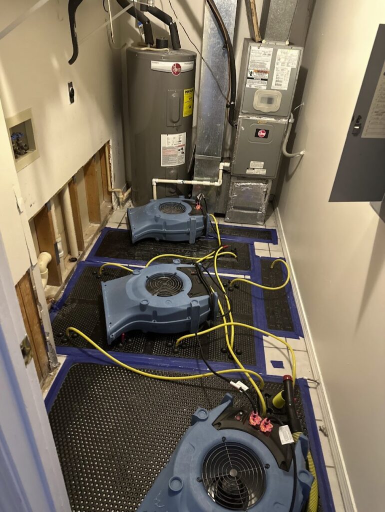 Water damage drying equipment around a water heater after a leak in a Northeast Ohio home